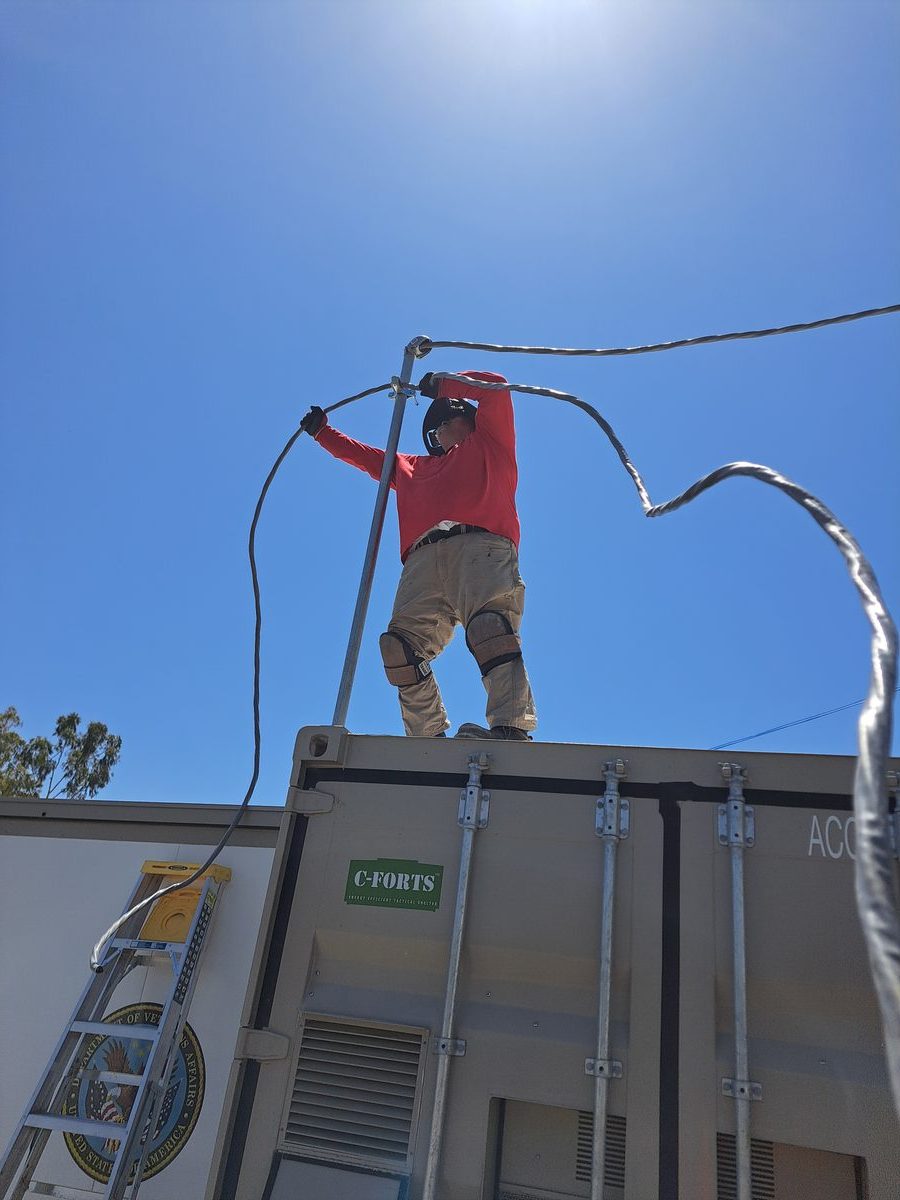 America One Mechanical technician working on HVAC system on job site